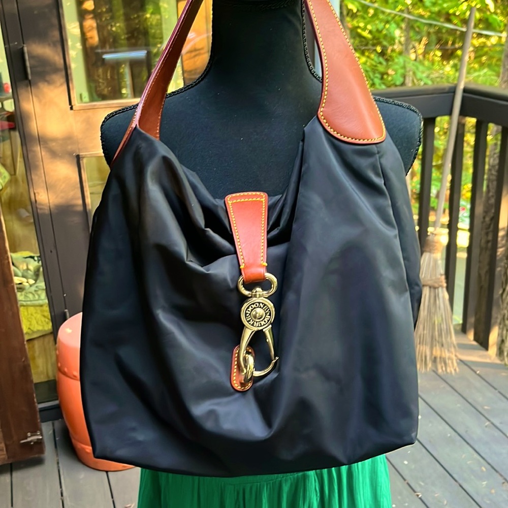 Dooney & Bourke black nylon shoulder bag with leather shoulder strap.